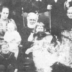 John Marshall Wilson sitting in chair with children and family