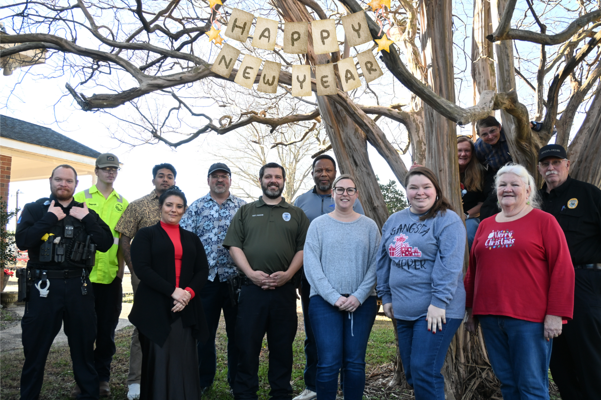 Town Hall and Police Department staff standing in front of tree
